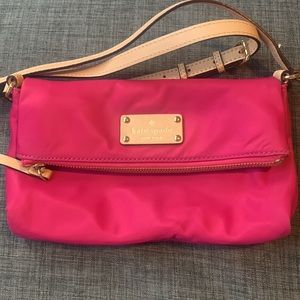 Small pink Kate Spade fold-over crossbody purse